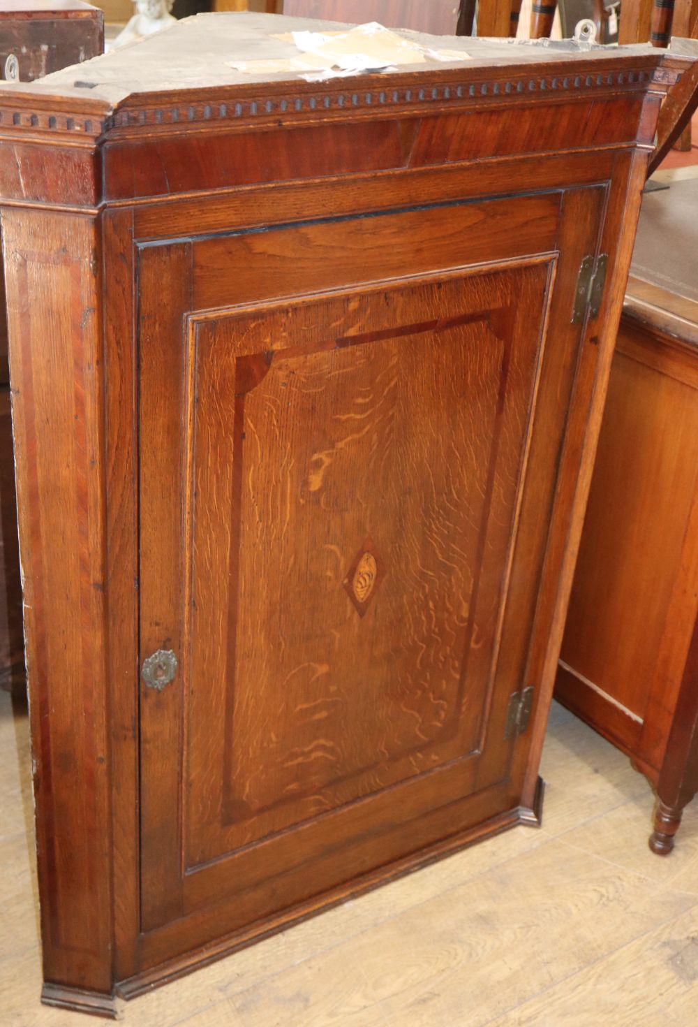 A George III oak hanging corner cupboard, W.82cm, D.41cm, H.106cm